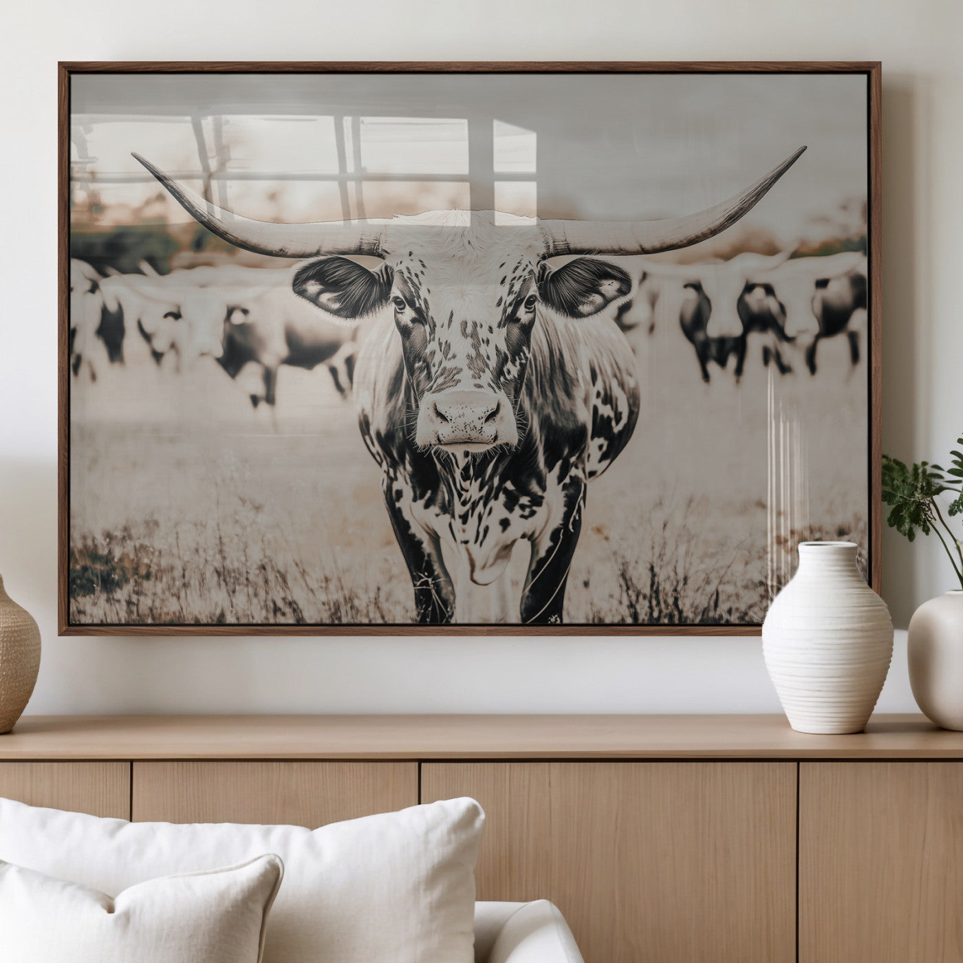 Canvas of a speckled Texas longhorn standing boldly in a field with a herd behind, perfect for rustic western or farmhouse wall decor.