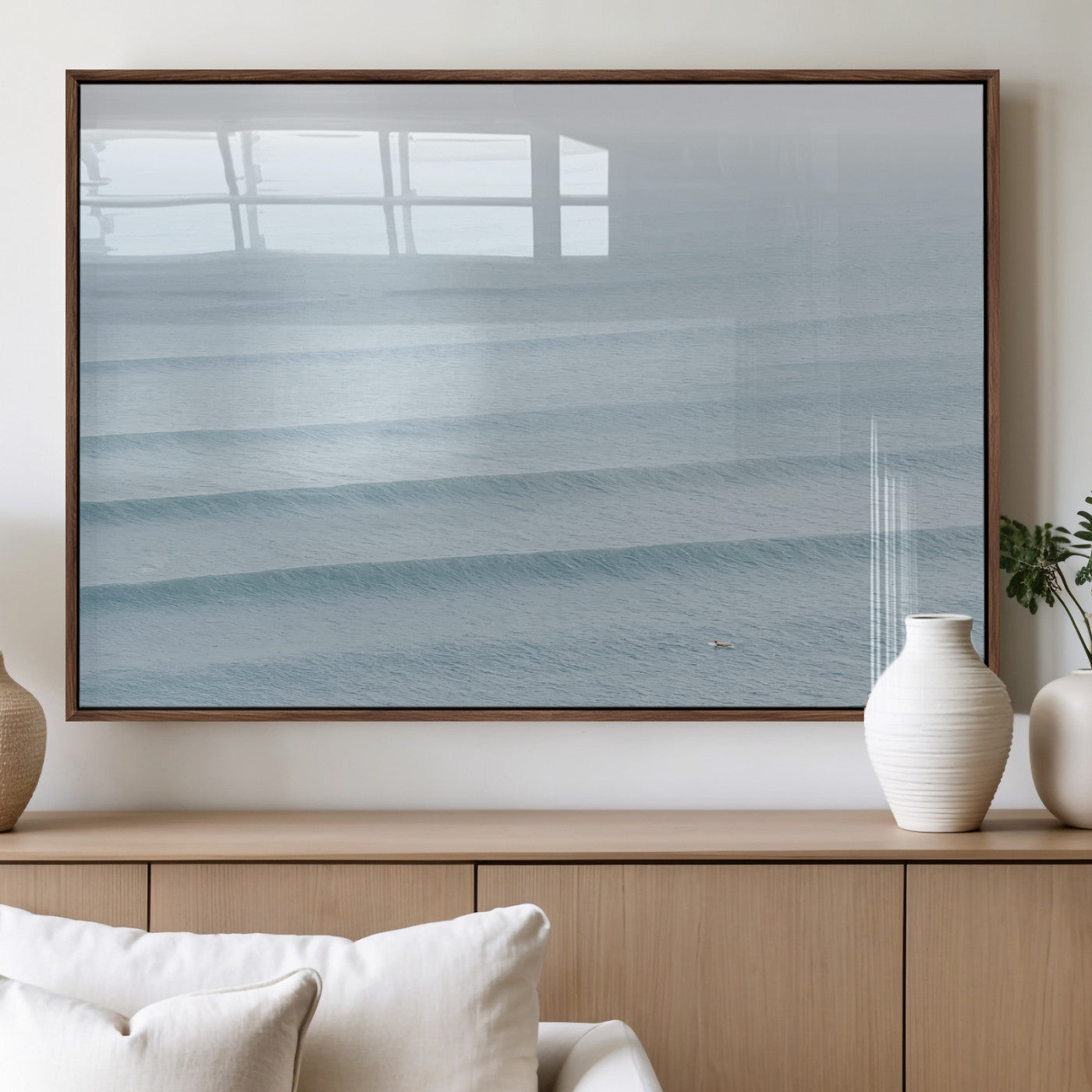 Framed canvas of repeating ocean waves with a distant solo surfer, ideal for minimalist ocean or calm coastal wall decor.