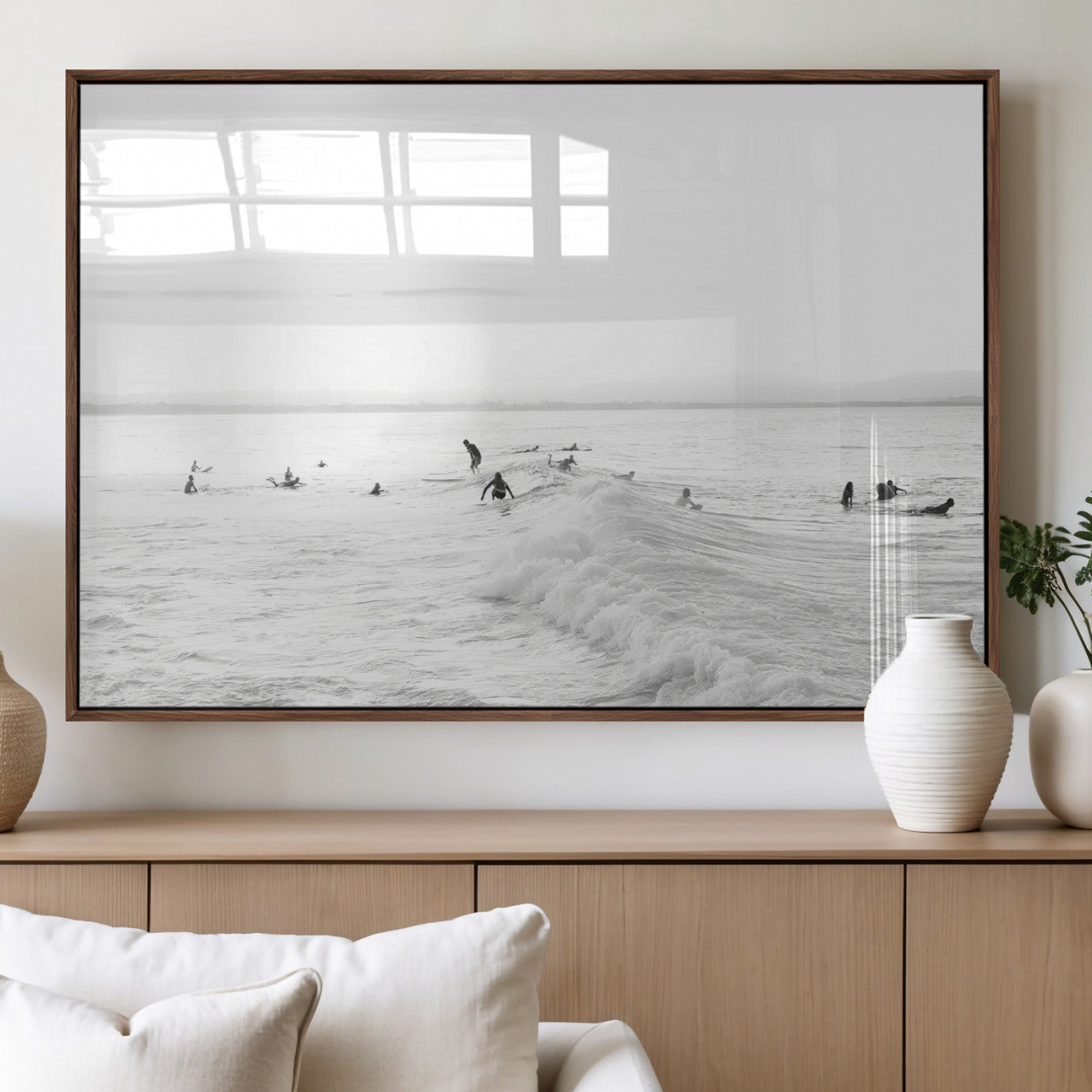 Monochrome photo of surfers riding and waiting on ocean waves, ideal for surf-themed or coastal energy wall decor.