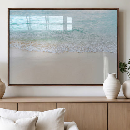 Soft shoreline with gentle aqua waves on smooth sand, ideal for minimalist coastal or pastel ocean-inspired home wall decor.