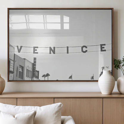 Black and white photo of Venice Beach sign and palm-lined street, perfect for urban coastal or minimalist LA-inspired wall decoration.