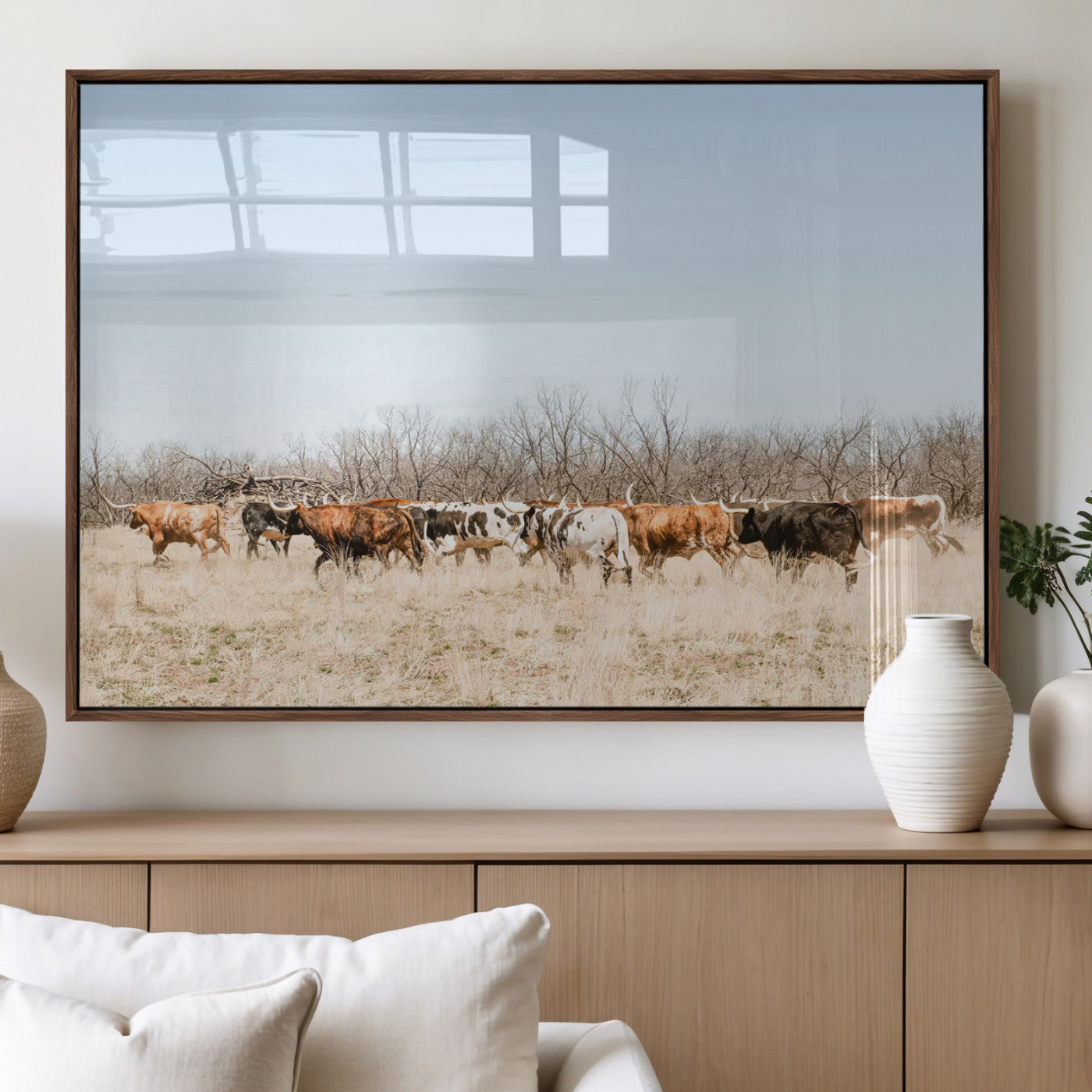 Framed wall art of Texas longhorn cattle walking through a dry, neutral-toned prairie, perfect for rustic farmhouse or western-themed home decor.