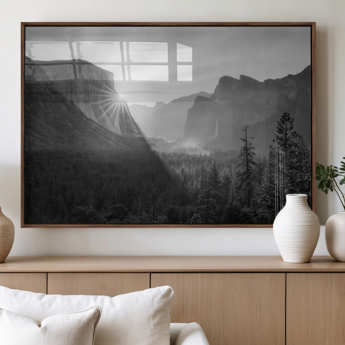 Black and white landscape of Yosemite with sun rays peeking over El Capitan, ideal for moody nature or modern rustic decor.