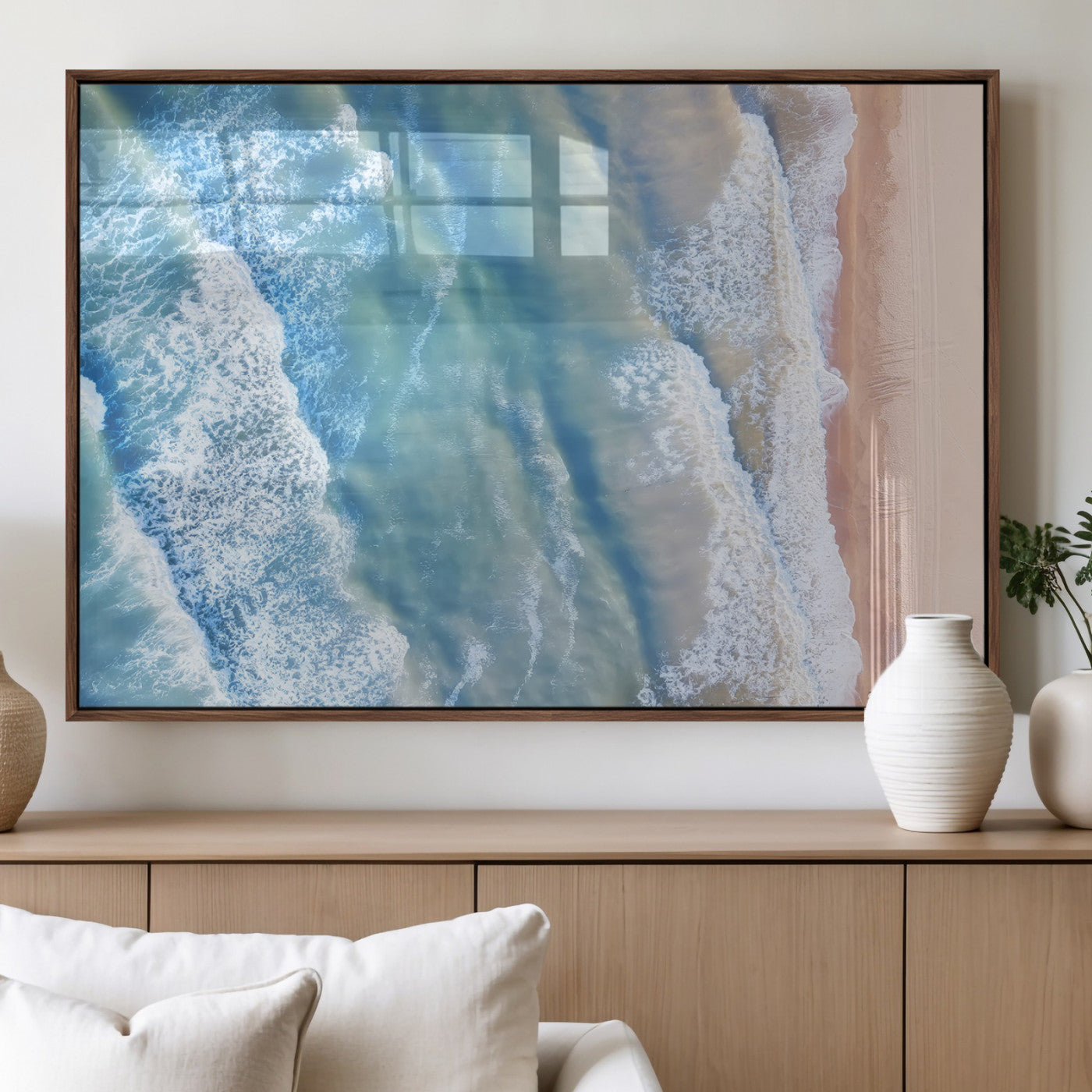 Aerial photo of soft blue waves meeting sandy shore, perfect for modern coastal or beach-themed decor with a light and tranquil aesthetic.