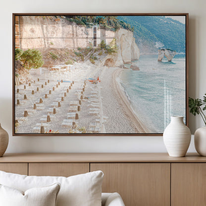 Wall art of a calm Mediterranean beach with rows of sun loungers and umbrellas in soft pastel tones, perfect for light coastal or vacation-themed decor.