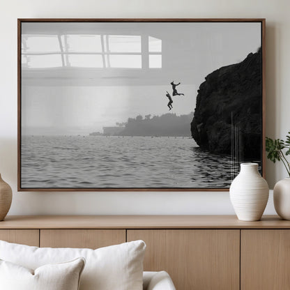 Black and white canvas of two figures cliff jumping into the sea, captured with moody tones, ideal for modern coastal or adventure-themed home decor.   2/2