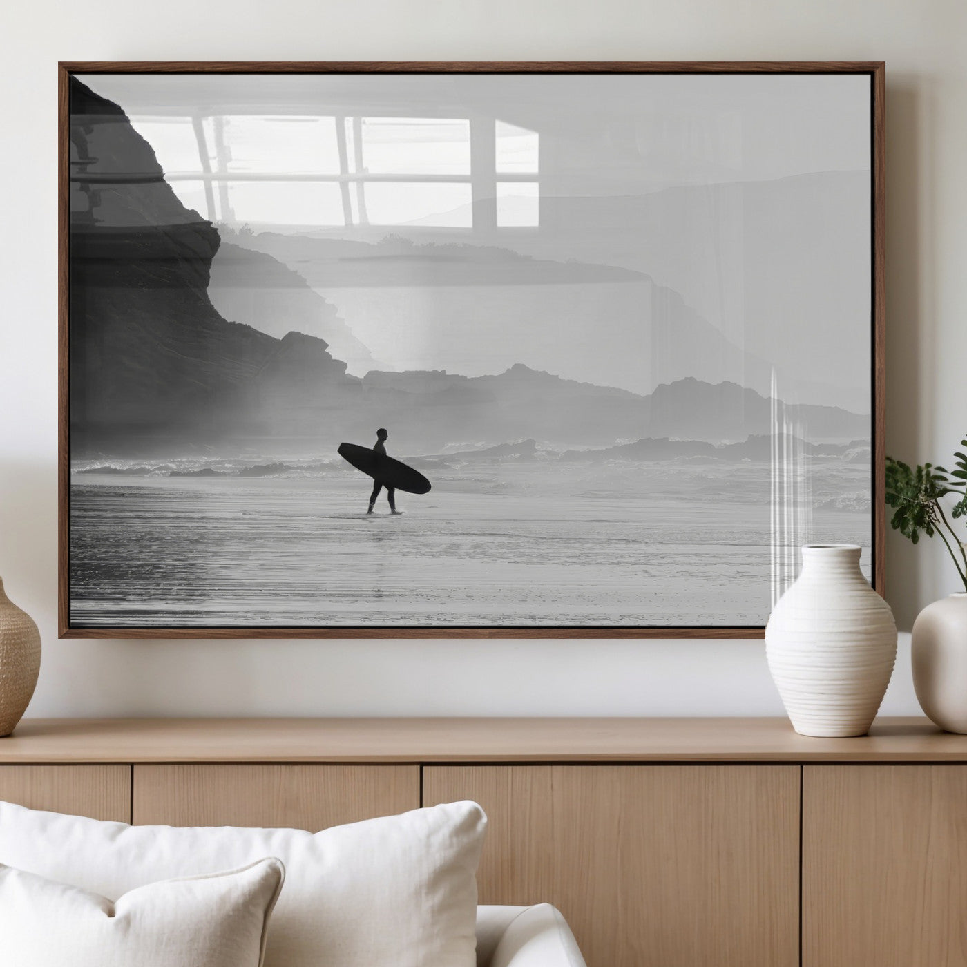A lone surfer walking along a misty beach with cliffs in the background, carrying their board, capturing a serene and minimal ocean moment.