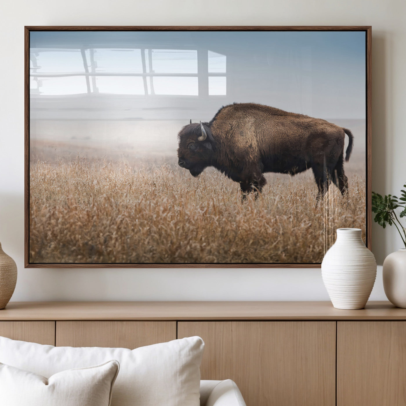 A majestic bison standing in an open prairie field, its strong form blending into the golden grass under a vast blue sky, evoking the wild spirit of the American plains.