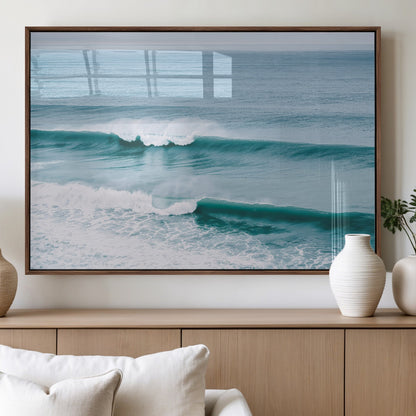 Powerful ocean waves rolling towards the shore, their turquoise hues blending with white sea foam under an open horizon, capturing the essence of the ocean's movement.