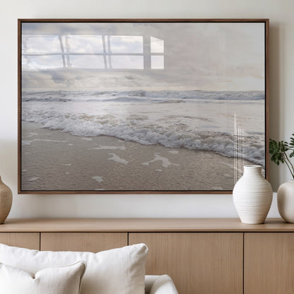 Peaceful ocean waves rolling onto the sandy shore under soft light, perfect for neutral or coastal minimalist decor themes.