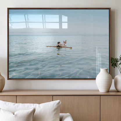 A peaceful minimalist scene of a person floating on crystal-clear water, surrounded by a vast open horizon, capturing relaxation and serenity in a tranquil aquatic setting.
