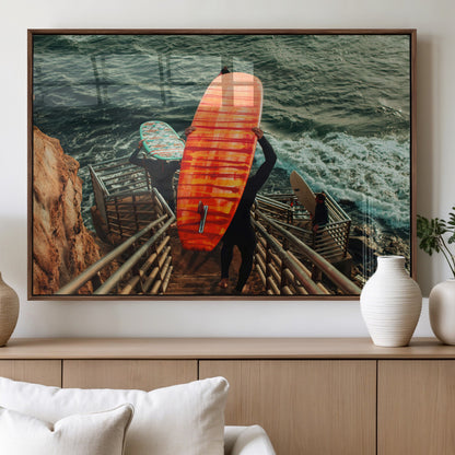 A surfer carrying a bold orange surfboard down a rugged staircase toward the ocean, bathed in golden hour light, capturing the energy of coastal adventure.