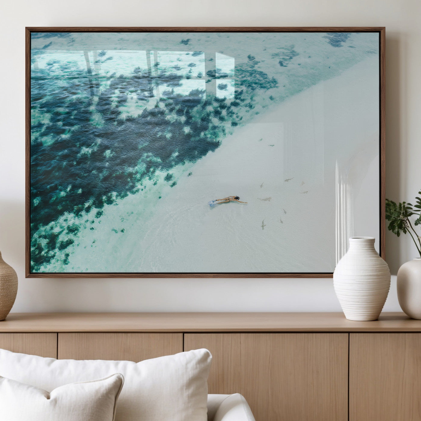 Canvas featuring an aerial view of a swimmer in shallow turquoise waters with coral patterns, ideal for tropical coastal home decor.
