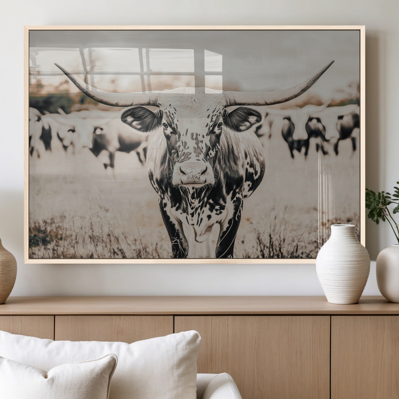 Canvas of a speckled Texas longhorn standing boldly in a field with a herd behind, perfect for rustic western or farmhouse wall decor.