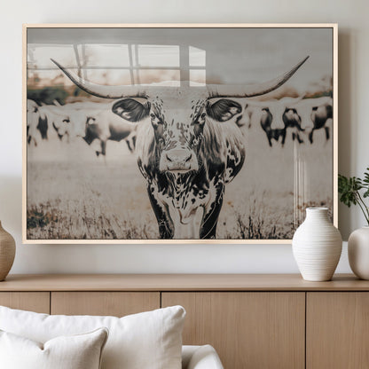 Canvas of a speckled Texas longhorn standing boldly in a field with a herd behind, perfect for rustic western or farmhouse wall decor.