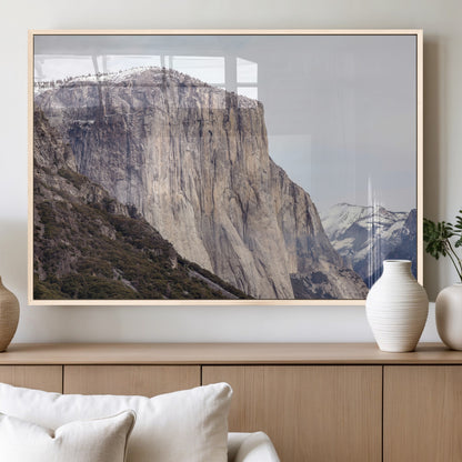 Framed canvas of El Capitan’s vertical granite face in Yosemite with snowy peaks, ideal for Sierra minimalism or mountain-inspired decor.