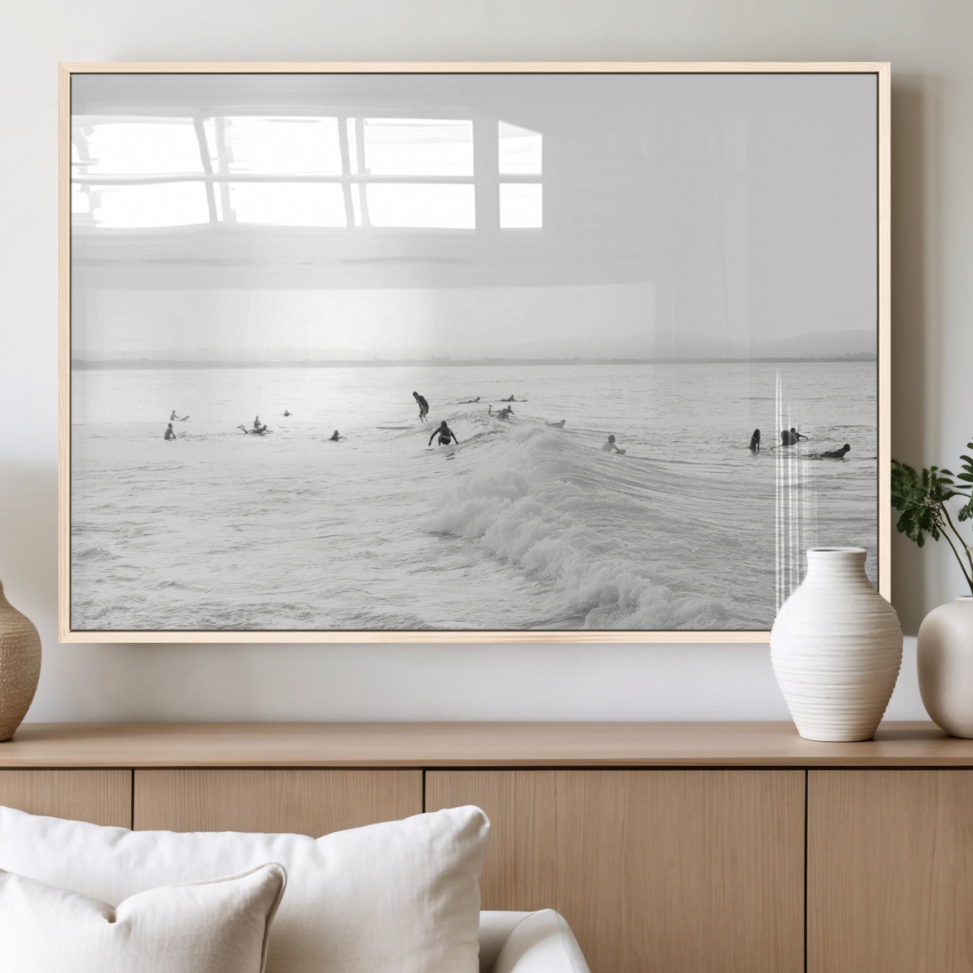 Monochrome photo of surfers riding and waiting on ocean waves, ideal for surf-themed or coastal energy wall decor.