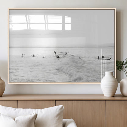 Monochrome photo of surfers riding and waiting on ocean waves, ideal for surf-themed or coastal energy wall decor.