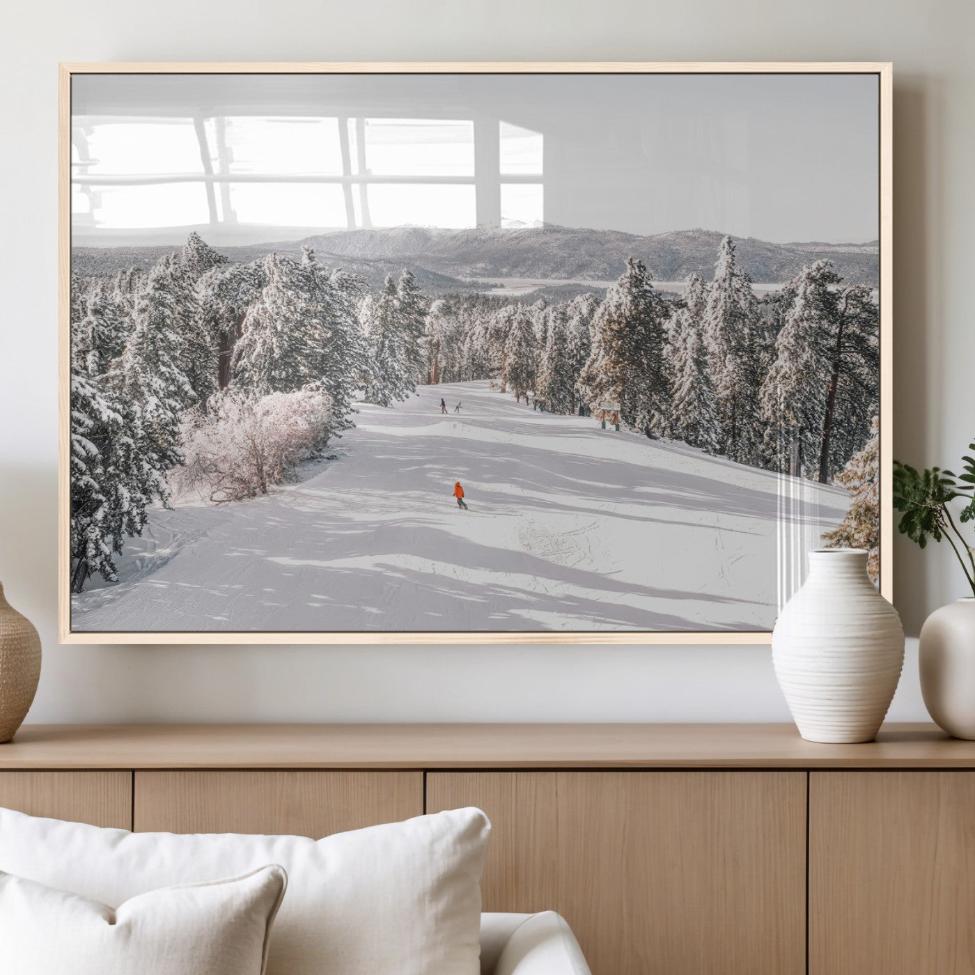Bright ski trail lined with snow-covered pines and a skier in orange, perfect for alpine adventure or winter sports-inspired decor.