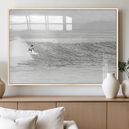 Monochrome photo of a surfer riding a wave with distant mountains, ideal for coastal motion or black and white surf-themed wall decor.