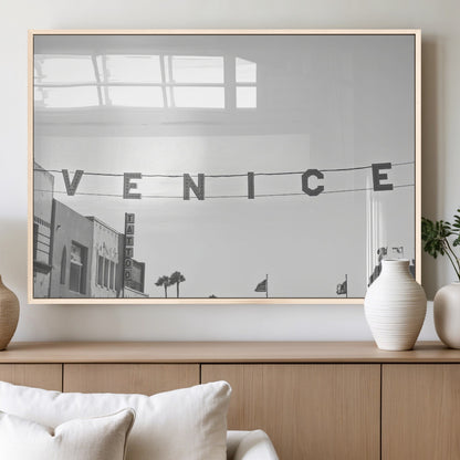 Black and white photo of Venice Beach sign and palm-lined street, perfect for urban coastal or minimalist LA-inspired wall decoration.