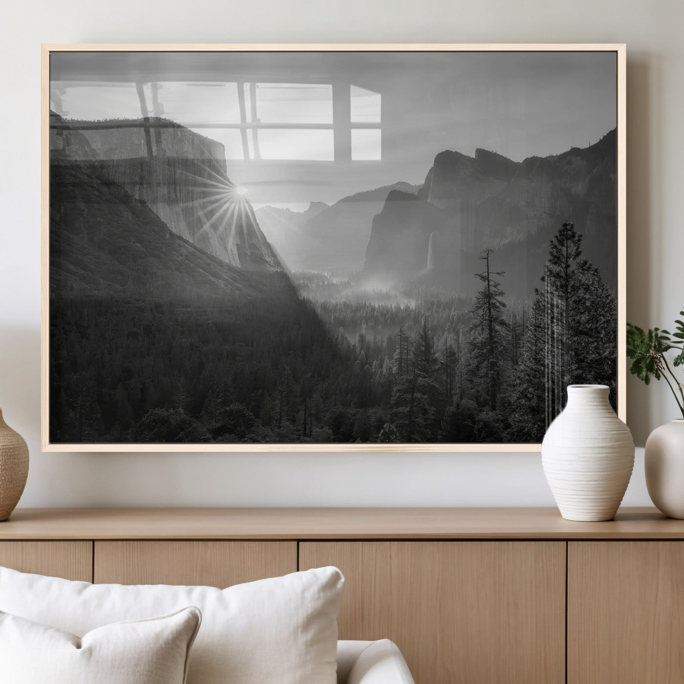 Black and white landscape of Yosemite with sun rays peeking over El Capitan, ideal for moody nature or modern rustic decor.