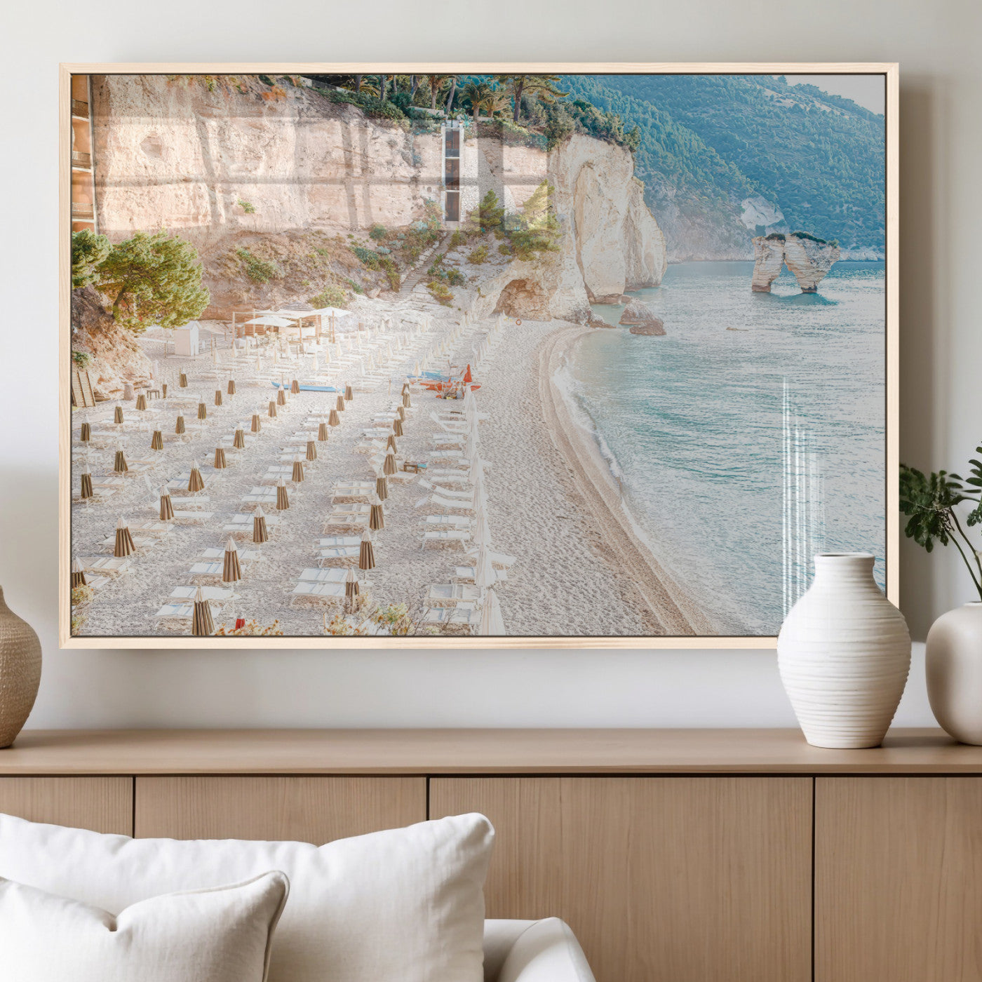 Wall art of a calm Mediterranean beach with rows of sun loungers and umbrellas in soft pastel tones, perfect for light coastal or vacation-themed decor.