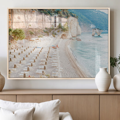 Wall art of a calm Mediterranean beach with rows of sun loungers and umbrellas in soft pastel tones, perfect for light coastal or vacation-themed decor.
