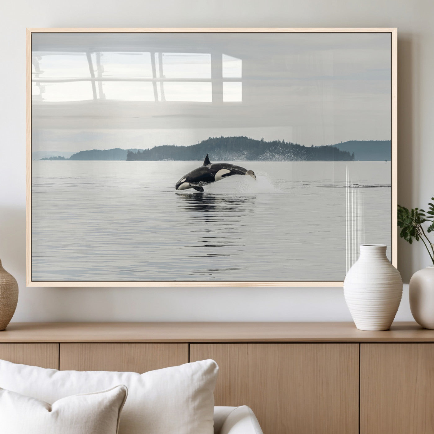 An orca jumping out of calm ocean waters with a misty island in the background, creating a serene and minimalist marine wildlife scene.