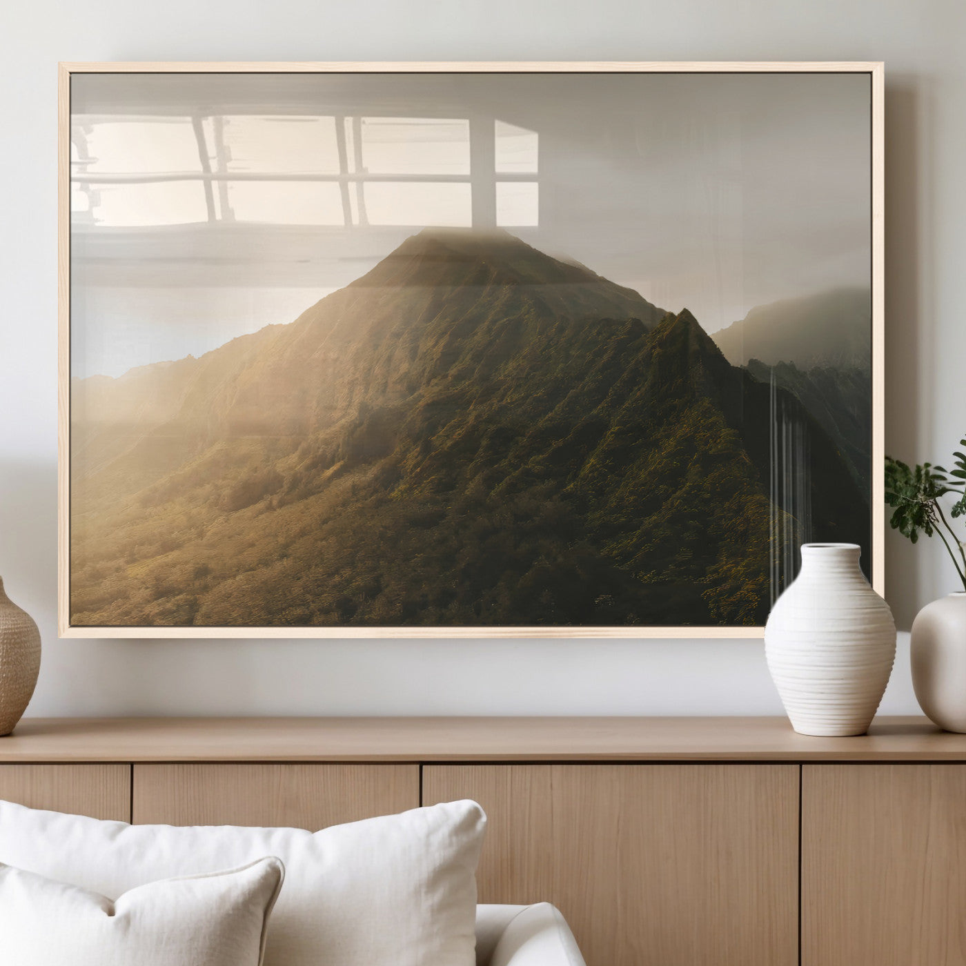 Sunlit mountain peak with mist rolling over its rugged slopes, bathed in golden light, creating a warm and tranquil nature-inspired scene.