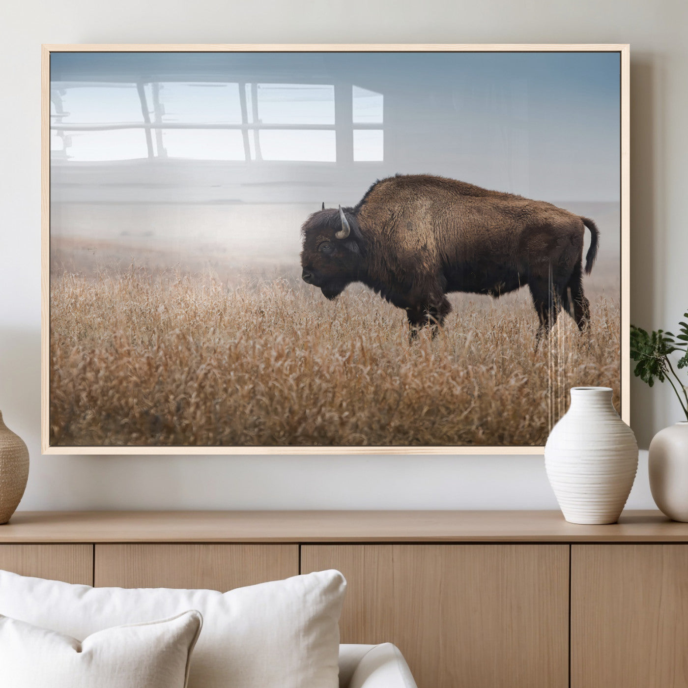 A majestic bison standing in an open prairie field, its strong form blending into the golden grass under a vast blue sky, evoking the wild spirit of the American plains.