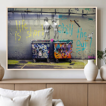 Graffiti-style canvas art with bold text and two naked figures over urban dumpsters, ideal for edgy or street-style decor.