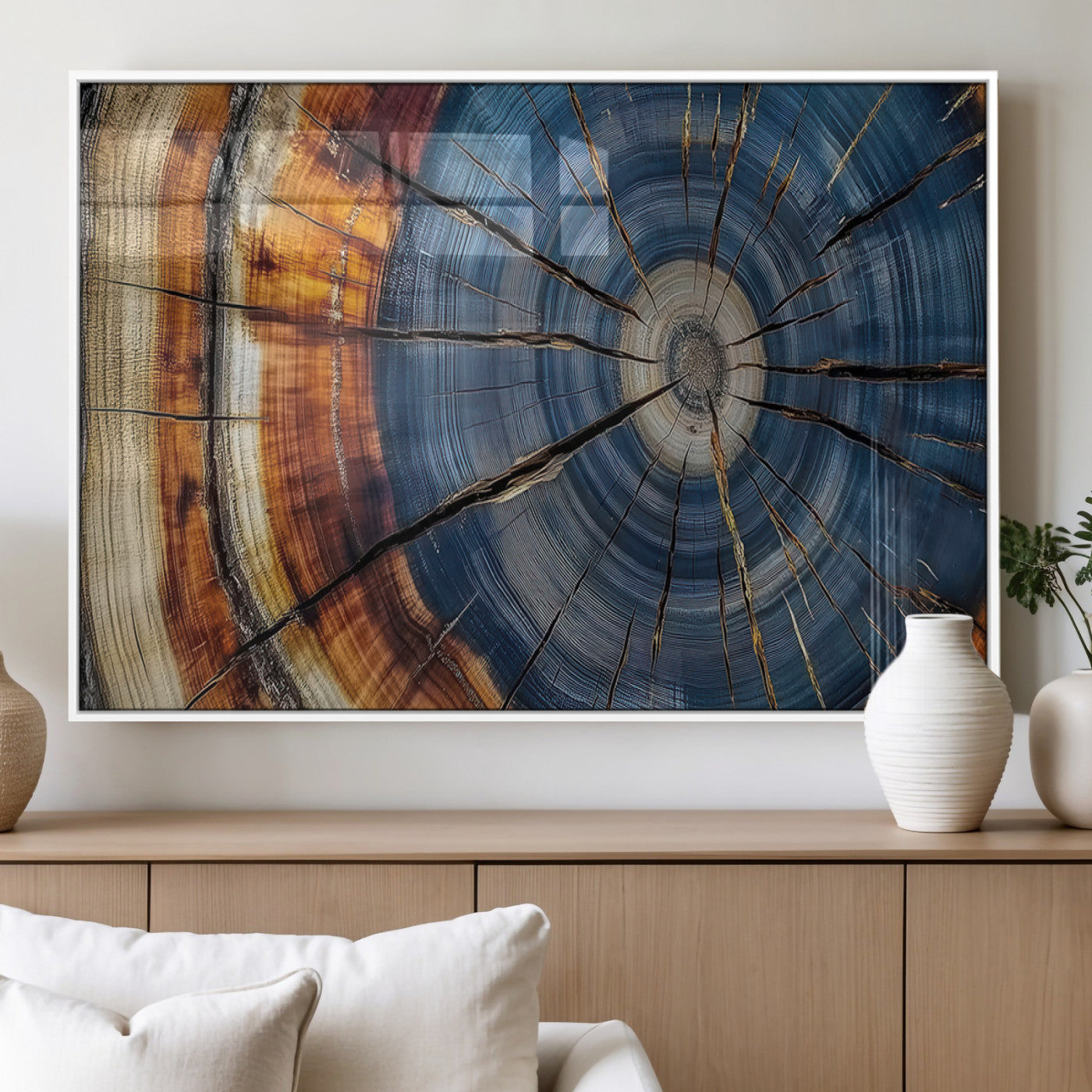 A stunning close-up view of a tree trunk, showcasing the intricate growth rings in a vibrant mix of warm browns, cool blues, and hints of natural texture.