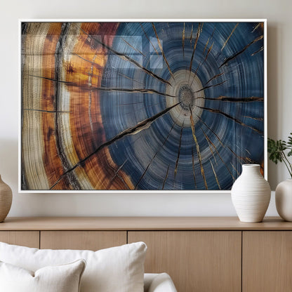 A stunning close-up view of a tree trunk, showcasing the intricate growth rings in a vibrant mix of warm browns, cool blues, and hints of natural texture.