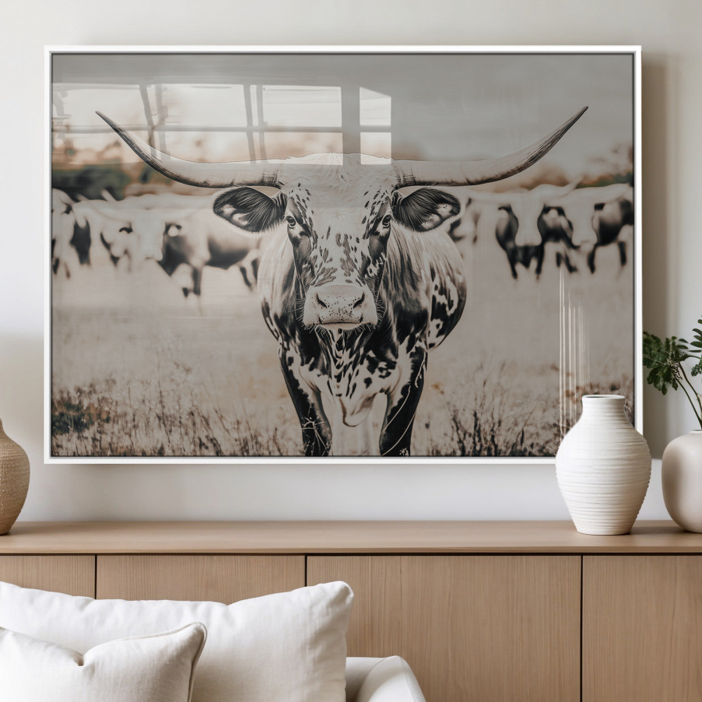 Canvas of a speckled Texas longhorn standing boldly in a field with a herd behind, perfect for rustic western or farmhouse wall decor.
