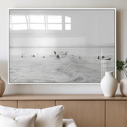 Monochrome photo of surfers riding and waiting on ocean waves, ideal for surf-themed or coastal energy wall decor.