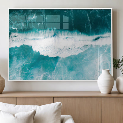 Aerial view of turquoise ocean waves crashing with white foam, perfect for tropical coastal or modern beach-style home decor.