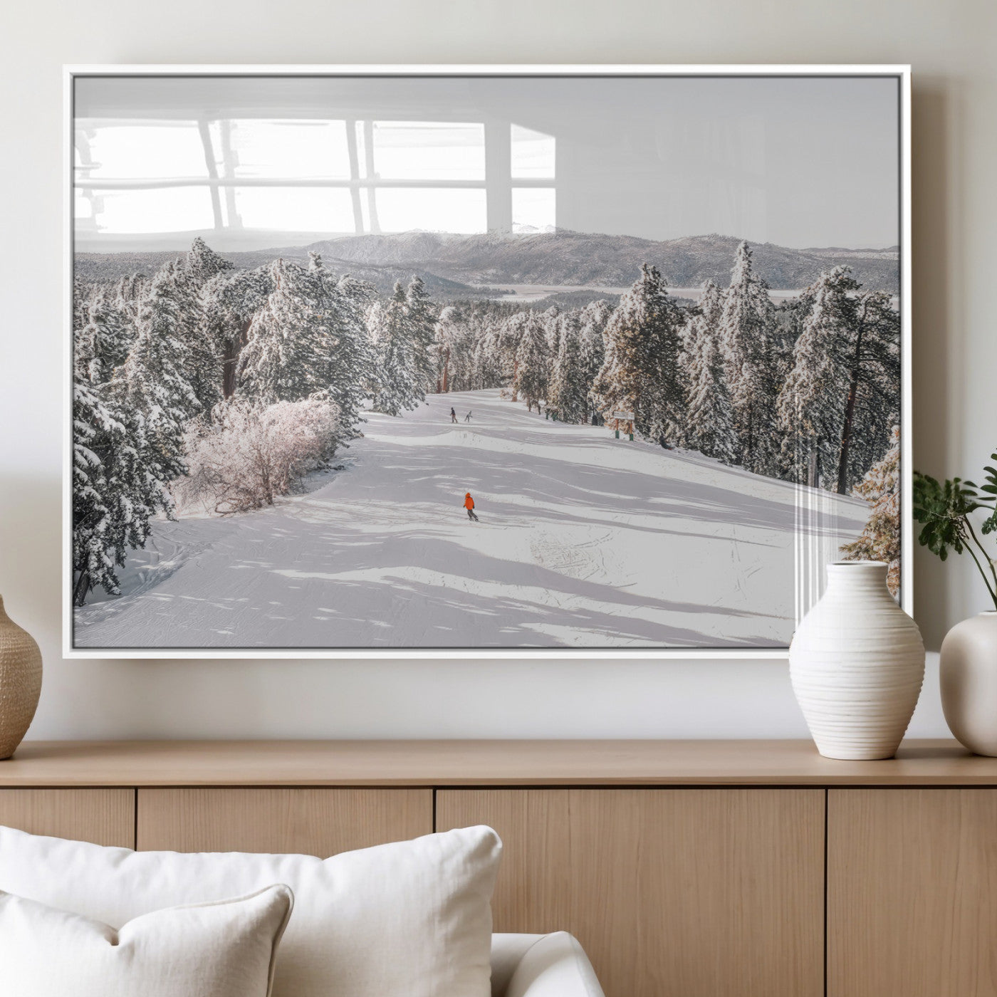 Bright ski trail lined with snow-covered pines and a skier in orange, perfect for alpine adventure or winter sports-inspired decor.