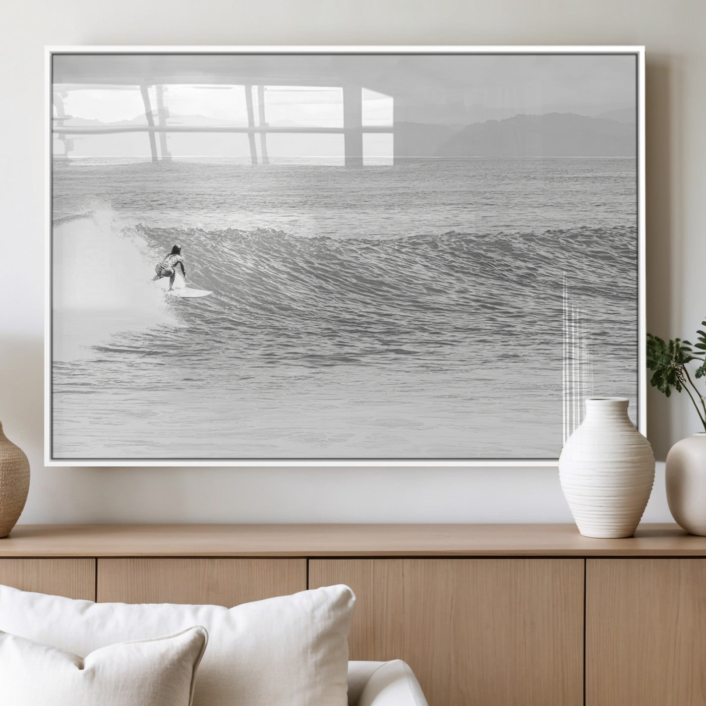 Monochrome photo of a surfer riding a wave with distant mountains, ideal for coastal motion or black and white surf-themed wall decor.