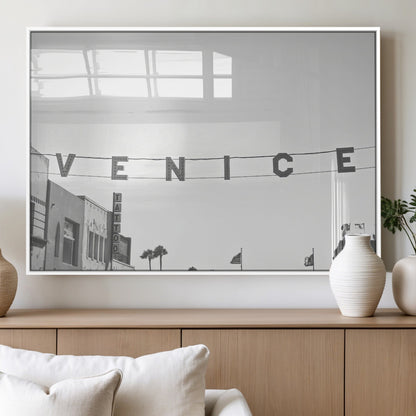 Black and white photo of Venice Beach sign and palm-lined street, perfect for urban coastal or minimalist LA-inspired wall decoration.