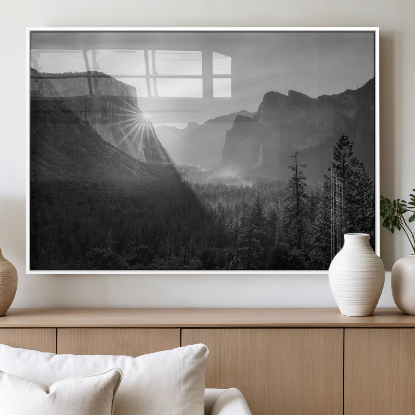 Black and white landscape of Yosemite with sun rays peeking over El Capitan, ideal for moody nature or modern rustic decor.