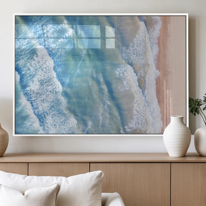Aerial photo of soft blue waves meeting sandy shore, perfect for modern coastal or beach-themed decor with a light and tranquil aesthetic.
