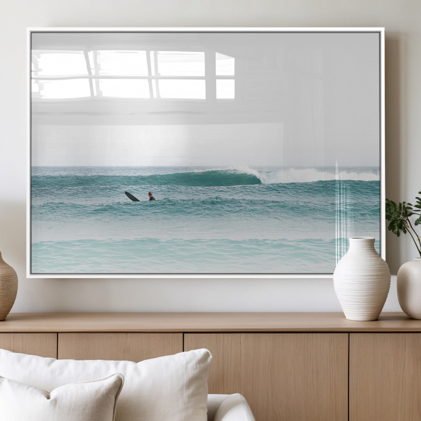 Minimalist photo of a lone surfer on calm aqua waves under bright sky, perfect for Scandinavian coastal or serene ocean-inspired home decor.