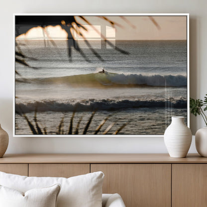 Photo of a surfer riding a golden hour wave at sunset, with tropical tones and dreamy light, perfect for tropical boho or coastal home decor.