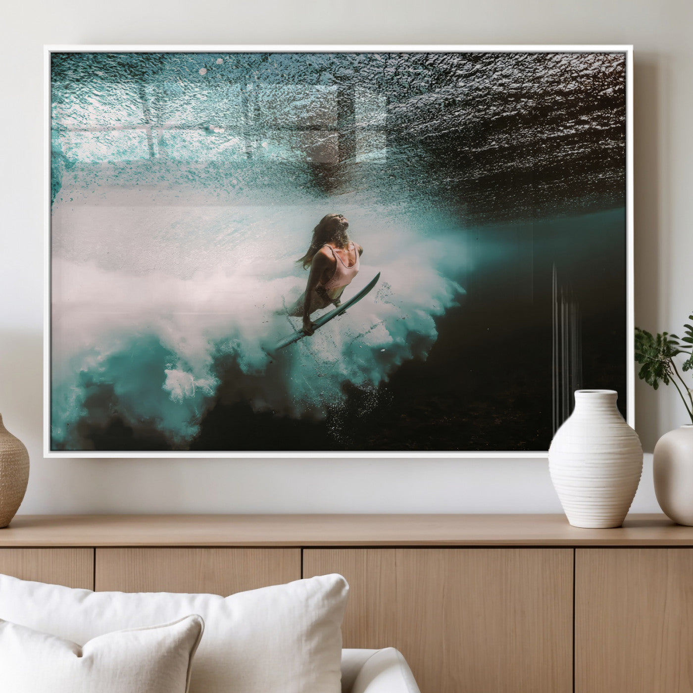 Vibrant underwater photo of a female surfer diving through turquoise waves, perfect for coastal boho or surf-inspired home decor.