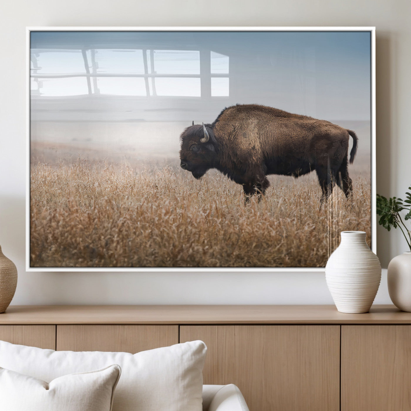 A majestic bison standing in an open prairie field, its strong form blending into the golden grass under a vast blue sky, evoking the wild spirit of the American plains.