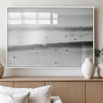 A monochrome photograph of swimmers gliding through gentle ocean waves, evoking a sense of calm and movement.