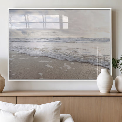Peaceful ocean waves rolling onto the sandy shore under soft light, perfect for neutral or coastal minimalist decor themes.