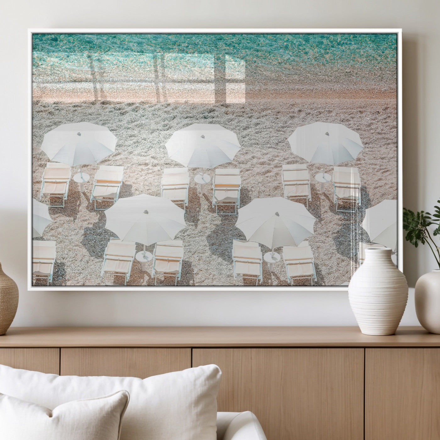 A bright beach scene with white umbrellas, pastel sand, and turquoise waters, creating a tranquil coastal vibe, perfect for beach house or summer decor.