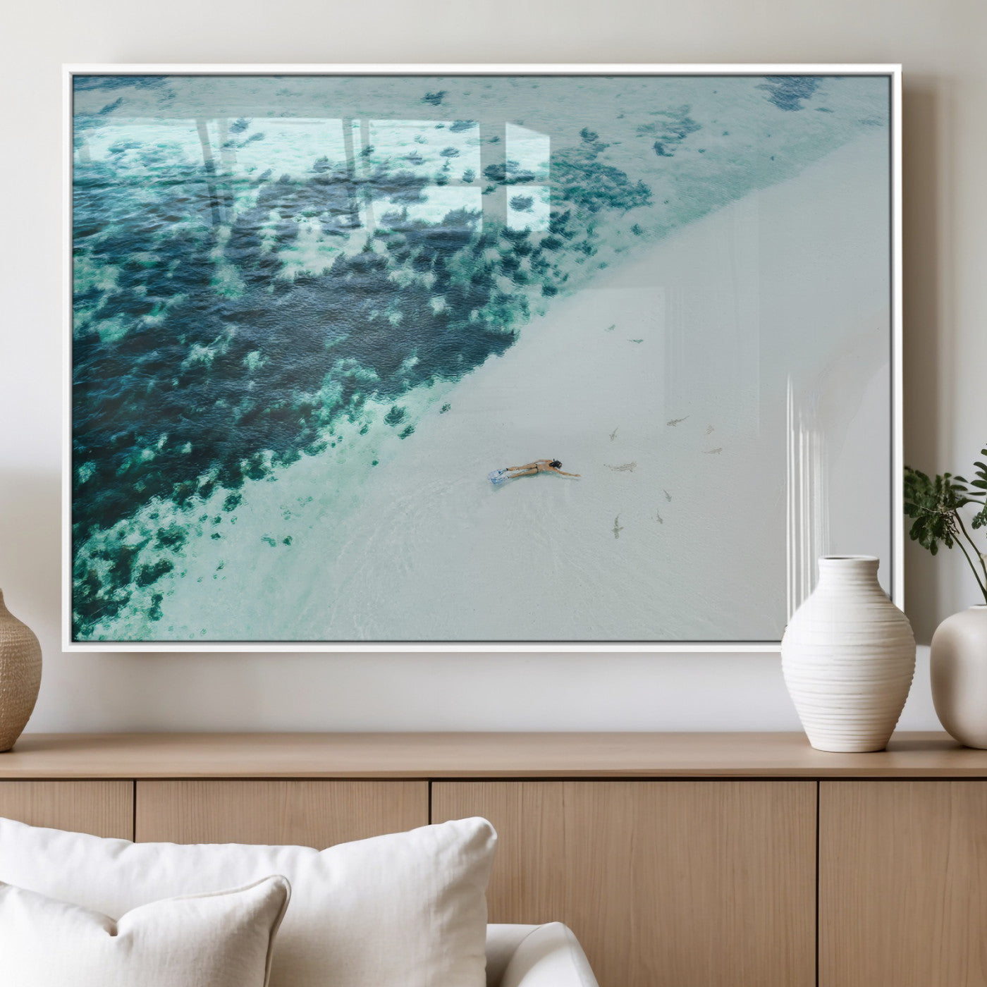 Canvas featuring an aerial view of a swimmer in shallow turquoise waters with coral patterns, ideal for tropical coastal home decor.